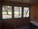 Sunroom featuring views of the landscaped yard through three large windows at 136 S Commercial St, Coleman, FL 33521