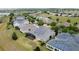Houses with solar panels. Aerial view capturing a quiet residential neighborhood with solar-paneled homes and green lawns at 142 Bayou Bend Rd, Groveland, FL 34736