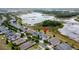 An aerial view of a home with great landscaping, near a lush green space offers a tranquil and desirable location at 142 Bayou Bend Rd, Groveland, FL 34736