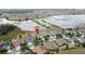 A pin on a house in a quiet, waterside neighborhood shows location and nearby amenities for easy living at 142 Bayou Bend Rd, Groveland, FL 34736