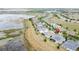 Aerial view showing the location of a home near a large body of water in a lovely neighborhood at 142 Bayou Bend Rd, Groveland, FL 34736