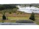 Aerial view of the backyard, pond, and solar panels, showcases this home's private, waterside lot at 142 Bayou Bend Rd, Groveland, FL 34736