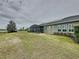 Large backyard features a covered patio with a screened lanai, and solar panels at 142 Bayou Bend Rd, Groveland, FL 34736