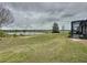 Beautiful, private backyard featuring stunning water views and a screened in lanai at 142 Bayou Bend Rd, Groveland, FL 34736