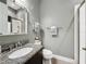 Bathroom with granite countertop, neutral color palette, tiled shower, and chrome fixtures at 142 Bayou Bend Rd, Groveland, FL 34736