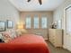 Bedroom featuring a ceiling fan, bright windows with modern shutters, closet, and neutral color palette at 142 Bayou Bend Rd, Groveland, FL 34736