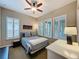 Bedroom featuring a ceiling fan, and bright windows with modern shutters and neutral color palette at 142 Bayou Bend Rd, Groveland, FL 34736