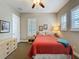 Bedroom featuring a ceiling fan, bright windows with modern shutters, and neutral color palette at 142 Bayou Bend Rd, Groveland, FL 34736