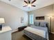 Neutral bedroom with plantation shutters, bench, ceiling fan, and comfortable striped bedding at 142 Bayou Bend Rd, Groveland, FL 34736