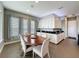 Bright dining area with abundant storage, black granite countertops, tile flooring, and large windows at 142 Bayou Bend Rd, Groveland, FL 34736