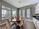 Cozy dining area with views of screened in porch overlooking lake with tile flooring and modern decor at 142 Bayou Bend Rd, Groveland, FL 34736