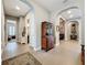 Inviting entryway featuring arched doorways, tile flooring, and beautiful decor pieces at 142 Bayou Bend Rd, Groveland, FL 34736