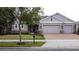 Beautifully landscaped single Gathering home with brick paver driveway and three car garage at 142 Bayou Bend Rd, Groveland, FL 34736