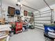Well-organized garage with ample storage, tool organization, and epoxy flooring at 142 Bayou Bend Rd, Groveland, FL 34736