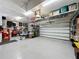 Spacious and well-lit garage featuring storage shelves and ample space for parking at 142 Bayou Bend Rd, Groveland, FL 34736