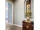 Hallway display with decorative cabinet, floral arrangement, and traditional artwork leading to bedroom at 142 Bayou Bend Rd, Groveland, FL 34736