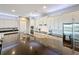 Modern kitchen with stainless steel appliances, white cabinets, and a dark granite countertop at 142 Bayou Bend Rd, Groveland, FL 34736