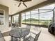 Spacious lanai with ample seating and a beautiful view of the serene lake at 142 Bayou Bend Rd, Groveland, FL 34736