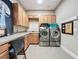 Bright laundry room featuring modern appliances and generous cabinet space at 142 Bayou Bend Rd, Groveland, FL 34736