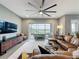 Stylish living room with large sectional, entertainment center, and sliding doors to the patio at 142 Bayou Bend Rd, Groveland, FL 34736
