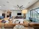 Spacious living room featuring a comfortable sectional sofa, and screened-in patio access at 142 Bayou Bend Rd, Groveland, FL 34736