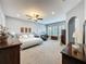 Spacious main bedroom with plantation shutters, dark wood furniture, carpet and ample natural light at 142 Bayou Bend Rd, Groveland, FL 34736