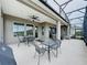 Covered outdoor patio, perfect for entertaining with views of the green backyard at 142 Bayou Bend Rd, Groveland, FL 34736