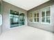 Covered patio featuring textured flooring and exterior shuttered windows at 142 Bayou Bend Rd, Groveland, FL 34736