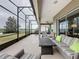 Spacious screened-in patio with comfortable seating, perfect for outdoor relaxation and entertaining at 142 Bayou Bend Rd, Groveland, FL 34736