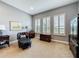 Comfortable sitting area features an elegant leather chair, a writing desk, and bright natural light at 142 Bayou Bend Rd, Groveland, FL 34736