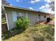 Single-story home featuring blue shutters and a red painted drive with manicured lawn at 15159 Sw 43Rd Terrace Rd, Ocala, FL 34473