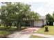 Charming single Gathering home with mature landscaping, light shutters, and a two car garage at 15159 Sw 43Rd Terrace Rd, Ocala, FL 34473