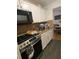 The compact kitchen features modern appliances, light cabinets and countertops, and black floors at 15159 Sw 43Rd Terrace Rd, Ocala, FL 34473