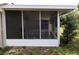 Enclosed and cozy screened-in porch offering a comfortable space to enjoy the outdoors at 15159 Sw 43Rd Terrace Rd, Ocala, FL 34473