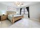 Bedroom with neutral walls, window providing light, and wood furniture creating a cozy feel at 1617 Lake Nettie Ct, Eustis, FL 32726