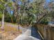 Private driveway leads to a serene property nestled among lush greenery and trees draped with Spanish moss at 1617 Lake Nettie Ct, Eustis, FL 32726