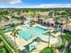 Community clubhouse aerial view showing pool, hot tub, lounge chairs, umbrellas, manicured landscaping, and gathering areas at 1738 Sw 157Th Place Rd, Ocala, FL 34473