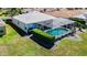 Real estate showcasing screened pool, complemented by a well-maintained lawn, and mature landscaping at 1738 Sw 157Th Place Rd, Ocala, FL 34473