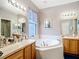 Well-appointed bathroom featuring a soaking tub, dual sinks, and lots of counter space at 1738 Sw 157Th Place Rd, Ocala, FL 34473