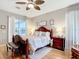 Spacious bedroom with ample natural light, wood floors, ceiling fan, and stylish furnishings at 1738 Sw 157Th Place Rd, Ocala, FL 34473