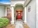 Inviting front entrance featuring a decorative door and manicured landscaping at 1738 Sw 157Th Place Rd, Ocala, FL 34473