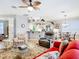 Comfortable living room featuring a ceiling fan, with bar access to the kitchen at 1738 Sw 157Th Place Rd, Ocala, FL 34473