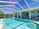 Sparkling pool with screened enclosure and patio area, perfect for outdoor relaxation and entertaining at 1738 Sw 157Th Place Rd, Ocala, FL 34473