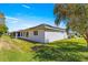 Backyard view of a home featuring solar panels and a screened in porch at 17594 Se 95Th Cir, Summerfield, FL 34491