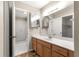 Bright bathroom with a large vanity, framed mirror, and a separate shower room at 17594 Se 95Th Cir, Summerfield, FL 34491