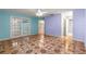 Bedroom with unique patterned flooring, bright walls, and a ceiling fan at 17594 Se 95Th Cir, Summerfield, FL 34491