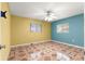 Bright bedroom featuring eye-catching tile floors, ceiling fan, and natural light from the window at 17594 Se 95Th Cir, Summerfield, FL 34491