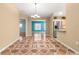 Open concept dining room with patterned floors, modern lighting, and access to kitchen and rooms at 17594 Se 95Th Cir, Summerfield, FL 34491