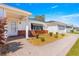 Charming single-story home with a brick-accented facade, manicured landscaping, and a two-car garage at 17594 Se 95Th Cir, Summerfield, FL 34491