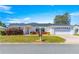 Charming single-story home with a well-manicured lawn, brick accents, and an attached two-car garage at 17594 Se 95Th Cir, Summerfield, FL 34491
